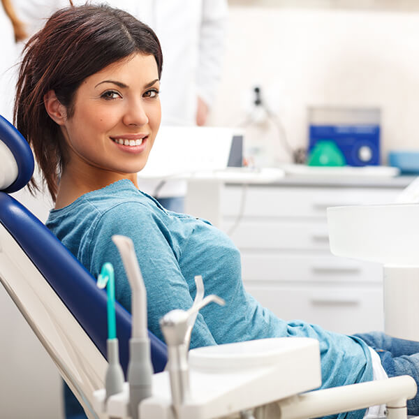 Young woman at the dentist smiling